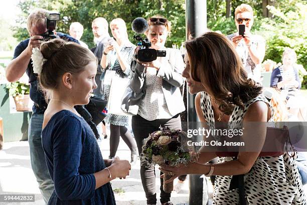 Princess Marie receives a a bouquet of flowers as she arrives to Copenhagen Jewllery and Watch Show where she presents award prize and talks to...