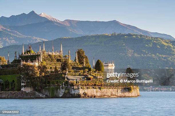 lake maggiore's isola bella with val grande mountains in the background. - stresa italy stock pictures, royalty-free photos & images