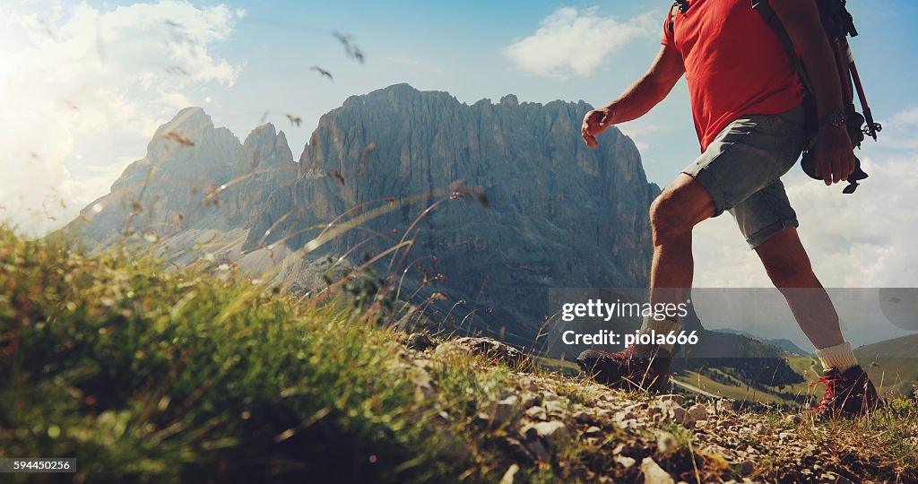 Senior man trail hiking on high mountain