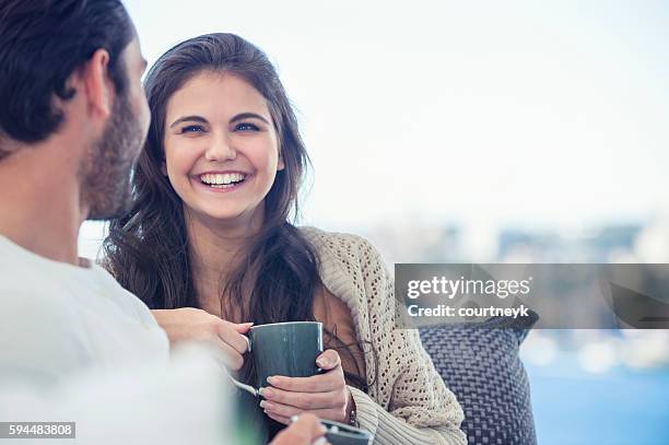 couple drinking coffee on the sofa. - australia capital cities stock pictures, royalty-free photos & images