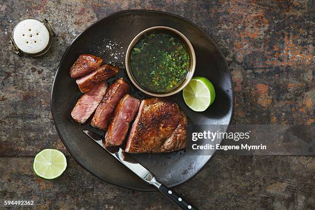 strip steak with chimichurri sauce - viande de boeuf photos et images de collection