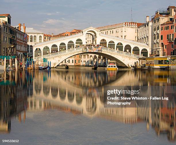 reflection of rialto bridge in grand canal of venice - rialto bridge stock pictures, royalty-free photos & images