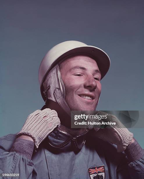 Studio portrait of British racing driver Stirling Moss, circa 1955 seen wearing the badge of the British Racing Drivers' Club.