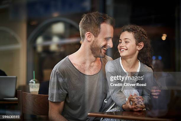 happy father and daughter in a restaurant - leanincollection dad stock pictures, royalty-free photos & images