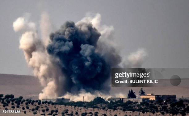 This picture taken from the Turkish Syrian border city of Karkamis in the southern region of Gaziantep, on August 24, 2016 shows smoke billows...