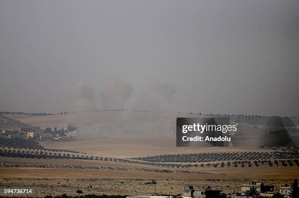 The photo taken from Karkamis district of the Turkey's Gaziantep province shows smoke rising as the Turkish fighter jets bomb Daesh targets in...