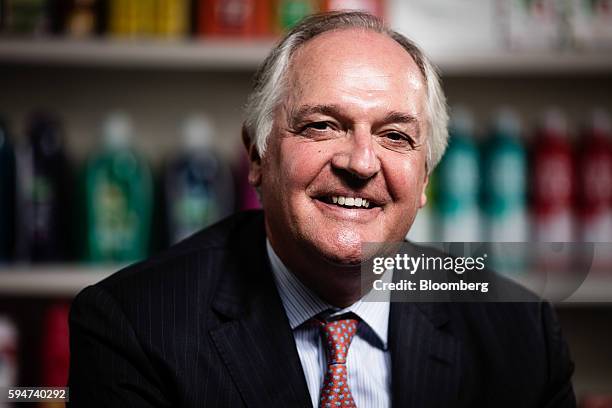 Paul Polman, chief executive officer of Unilever NV, poses for a photograph with a selection of Unilever products at their headquarters in London,...