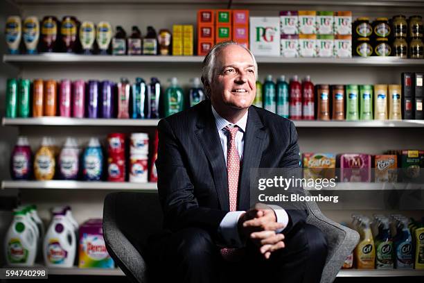 Paul Polman, chief executive officer of Unilever NV, poses for a photograph with a selection of Unilever products at their headquarters in London,...