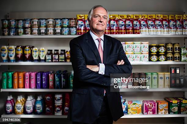 Paul Polman, chief executive officer of Unilever NV, poses for a photograph with a selection of Unilever products at their headquarters in London,...