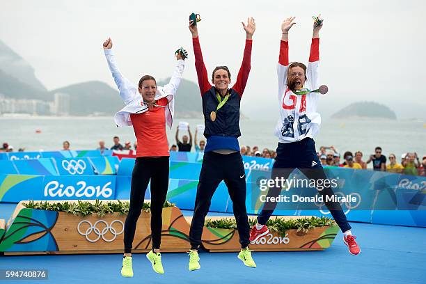 Summer Olympics: View of Switzerland Nicola Hug Spirig, USA Gwen Jorgensen, Great Britain Vicky Holland victorious with medals during presentation...