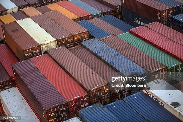Shipping containers sit stacked on the Hapag-Lloyd Holding AG Prague Express cargo ship at the Cia Siderurgica Nacional SA Sepetiba Tecon terminal...