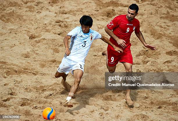 Shotaro Haraguchi of Japan competes for the ball with Mohammadali Mokhtari of Iran during the Continental Beach Soccer Tournament match between Japan...