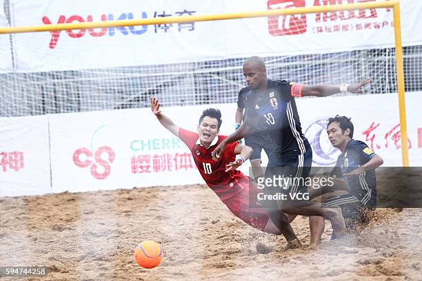 Ozu Moreira of Japan competes for the ball with Komkrit Nanan of Thailand during the Continental Beach Soccer Tournament match between Japan and...