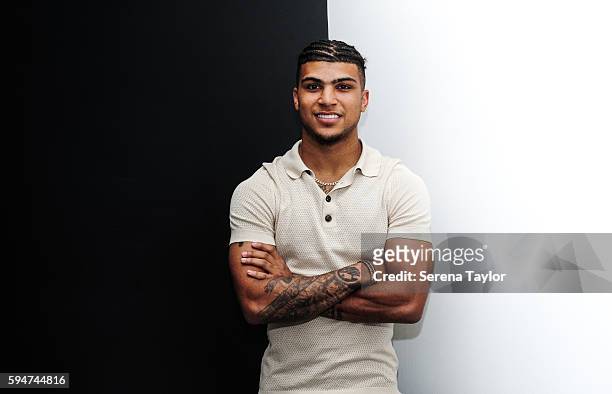 DeAndre Yedlin poses for photographs with a black and white wall after signing a 5 year contract at St.James' Park on August 24 in Newcastle upon...