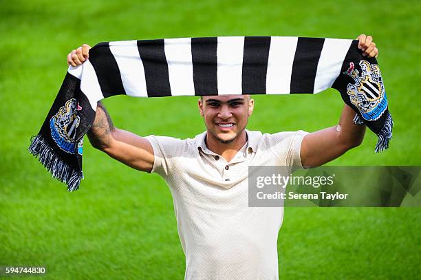 DeAndre Yedlin holds a club scarf on the pitch after signing a 5 year contract at St.James' Park on August 24 in Newcastle upon Tyne, England.