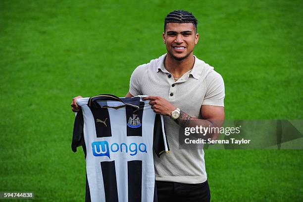 DeAndre Yedlin holds a club shirt on the pitch after signing a 5 year contract at St.James' Park on August 24 in Newcastle upon Tyne, England.