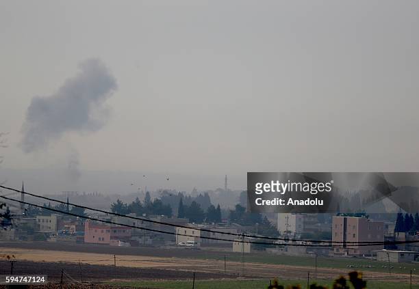 The photo taken from Karkamis district of the Turkey's Gaziantep province shows smoke rising as the Turkish fighter jets bomb Daesh targets in...