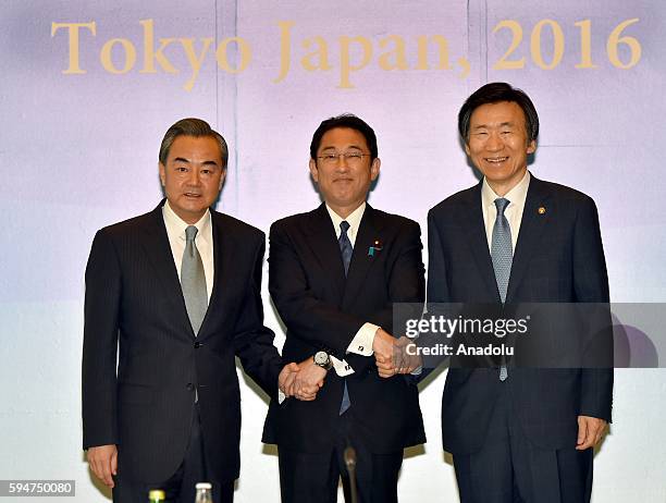 Japanese Foreign Minister Fumio Kishida , Chinese Foreign Minister Wang Yi , South Korean Foreign Minister Yun Byung-Se pose for the photo before...