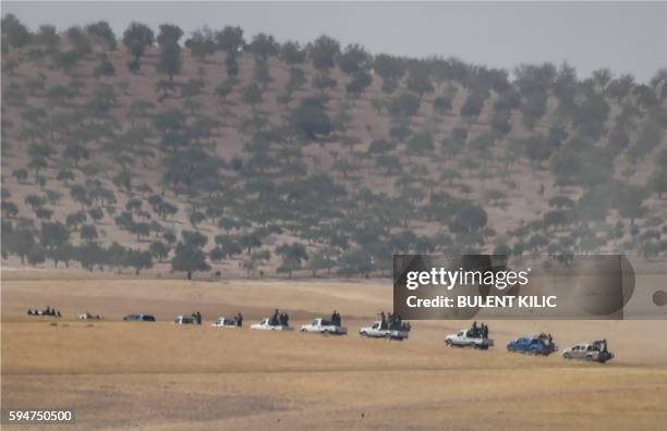 This picture taken from the Turkish Syrian border city of Karkamis in the southern region of Gaziantep, on August 24, 2016 shows pro-Ankara Syrian...