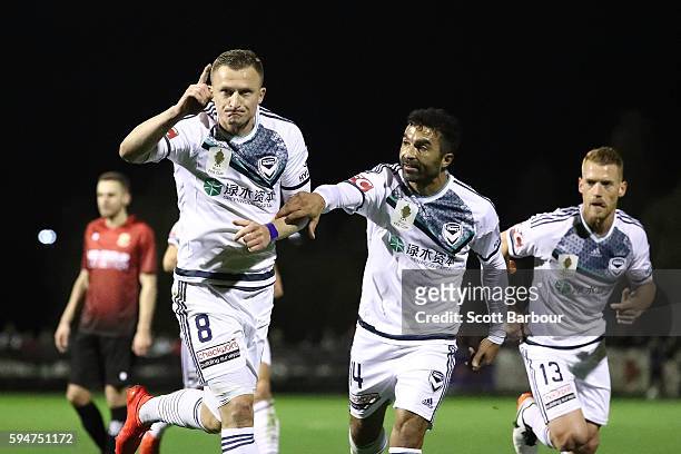 Besart Berisha of Melbourne Victory celebrates after scoring his sides first goal with Fahid Ben Khalfallah during the FFA Cup Round of 16 match...