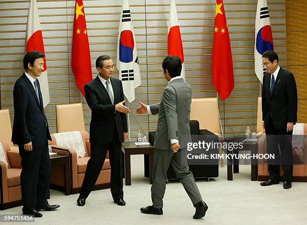 Japanese Prime Minister Shinzo Abe meets South Korean Foreign Minister Yun Byung-Se , Chinese Foreign Minister Wang Yi and Japanese Foreign Minister...