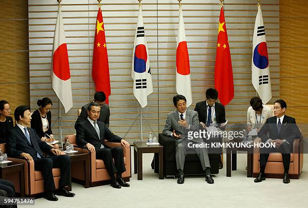 Japanese Prime Minister Shinzo Abe meets South Korean Foreign Minister Yun Byung-Se , Chinese Foreign Minister Wang Yi and Japanese Foreign Minister...