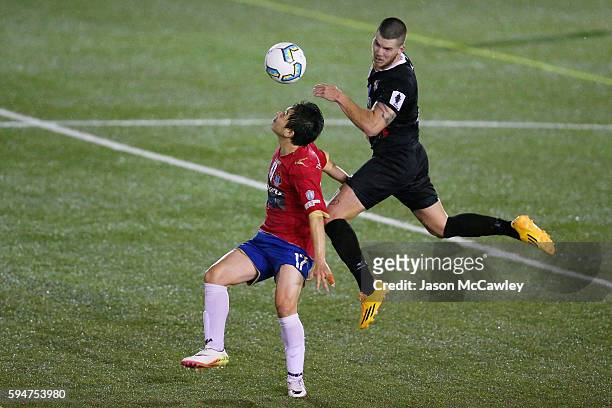 Mun-Soo Gil of Bonnyrigg is challenged by Travis Major of Blacktown during the round 16 FFA Cup match between Blacktown City and Bonnyrigg White...