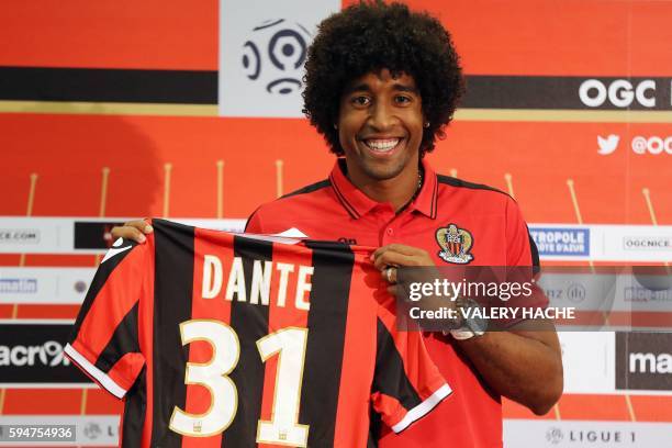 Nice's defender Brazilian Dante poses with a new jersey after a press conference on August 24, 2016 at the "Allianz Riviera" stadium in Nice,...