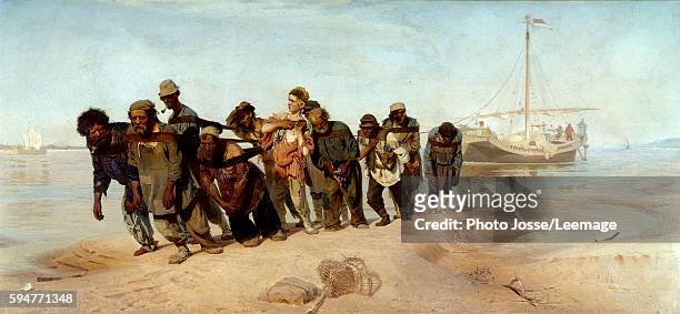 Barge haulers on the Volga. A group of men pulls a boat from the water in Russia. Painting by Ilya Efimovich Repin , oil on canvas, 1870-1873....