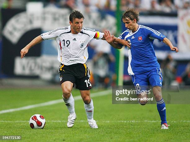 Bernd Schneider of Germany and Dusan Svento of Slovakia during the Group D Euro 2008 qualifying match between Germany and Slovakia at the AOL Arena...