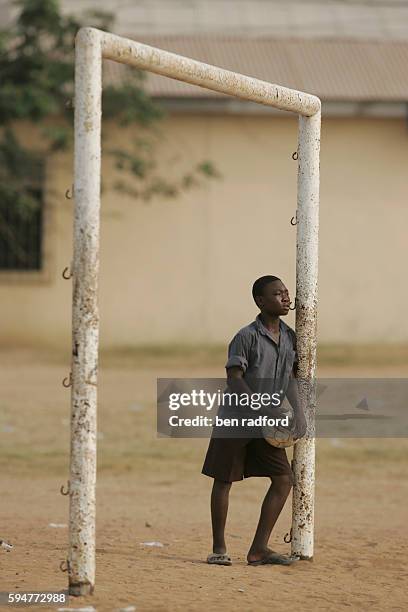 Watching a game of football in Teshie, near Accra, Ghana, West Africa.