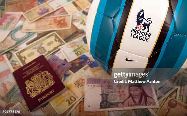 The Premier League ball surrounded by money from around the world and a passport. The English Premier League is considering the idea of staging some...