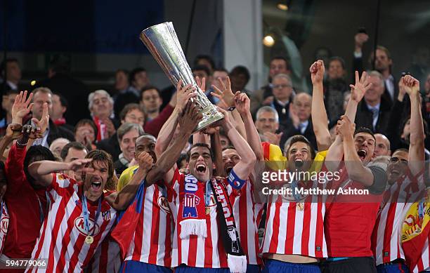 Antonio Lopez of Atletico Madrid lifts the Europa League Trophy after winning the final by beating Fulham 2-1