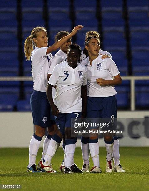 Fara Williams of England is congratulated by her team mates after scoring to make it 1-0