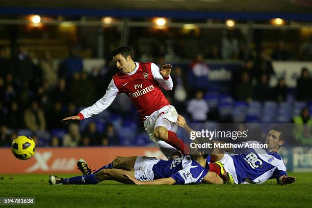 Robin van Persie of Arsenal gets tackled by Scott Dann and Roger Johnson of Birmingham City