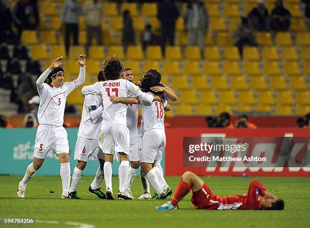 Iran celebrate a 1-0 victory over North Korea at the end of the game