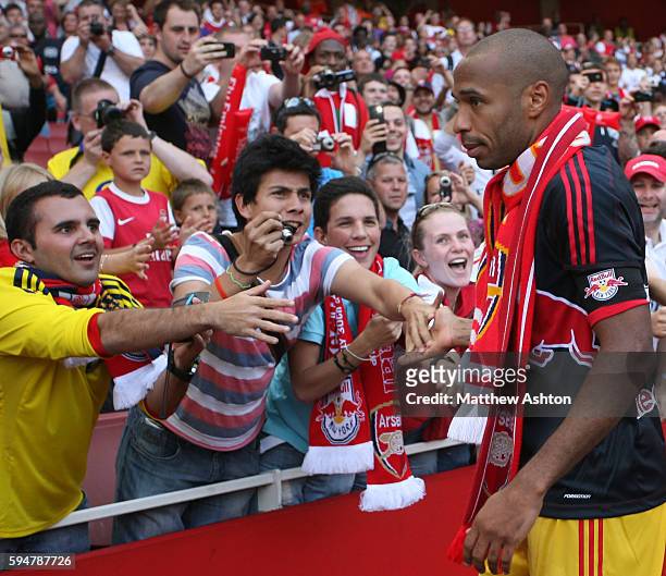 Thierry Henry of New York Red Bulls greets the Arsenal fans at the end of the match