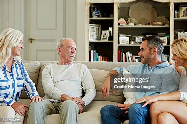 family spending leisure time at home - four people talking stock pictures, royalty-free photos & images