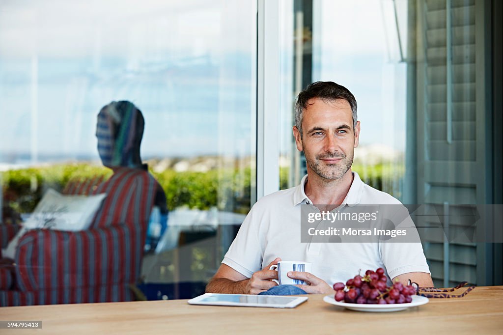 Man having coffee on patio