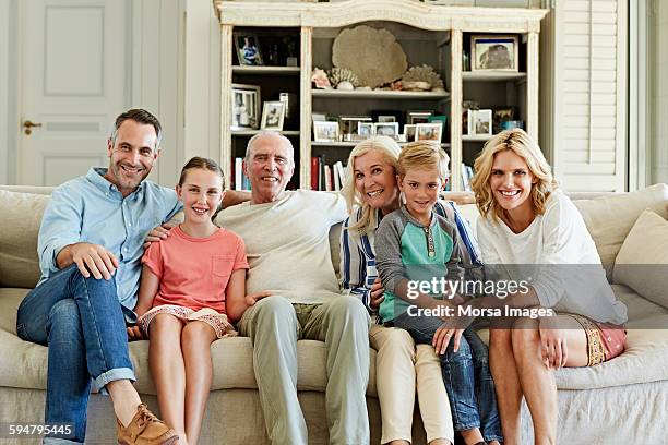 happy family sitting on sofa - grandmother son stock pictures, royalty-free photos & images