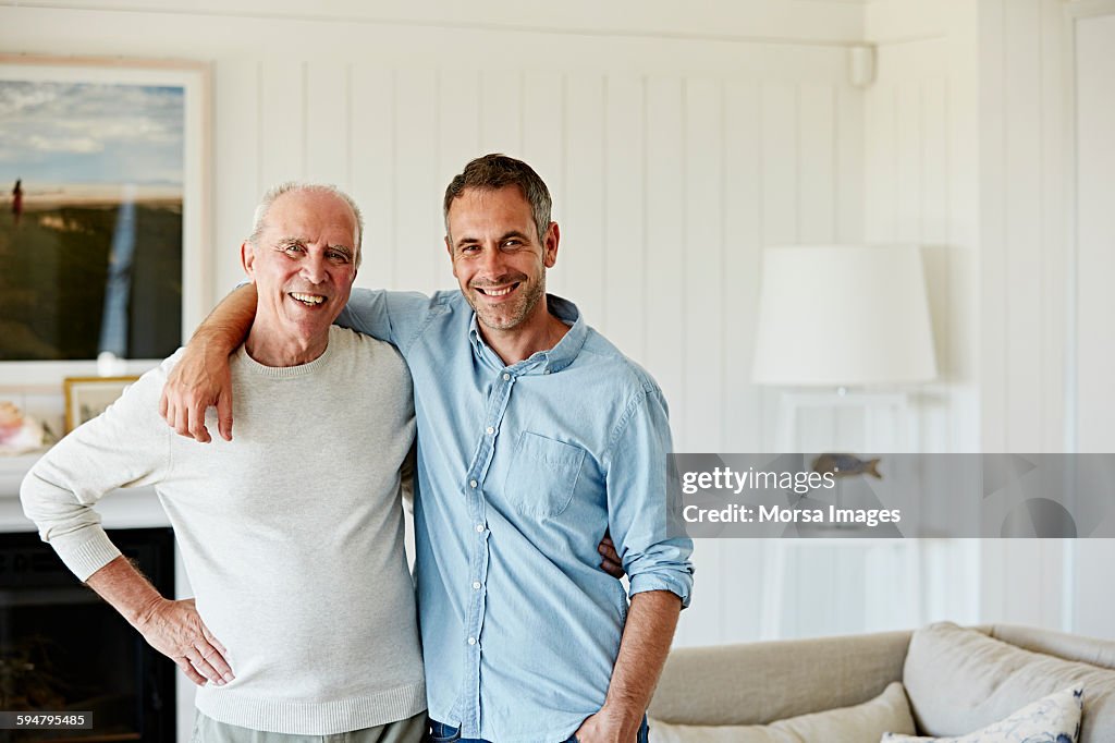Portrait of smiling father and son at home