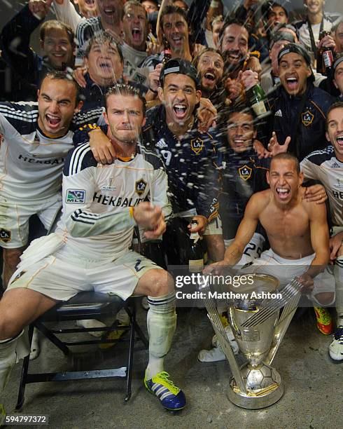 David Beckham of Los Angeles Galaxy celebrates in the dressing room by spraying champagne after winning the MLS Cup defeating Houston Dynamo 1-0 in...