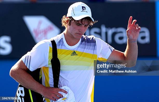Ben Mitchell of Australia walks off court dejected at the Australian Open, 2013