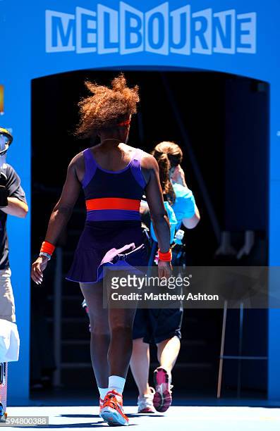 Serena Williams of USA walks off the court with the trainer at the Australian Open, 2013