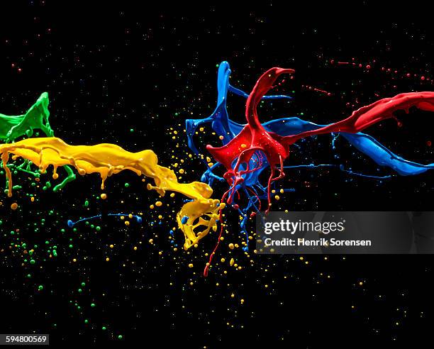 colored paint mixing mid air - brasses photos et images de collection