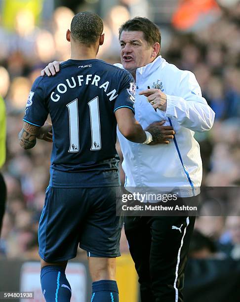 John Carver assistant manager of Newcastle United gives instructions to Yoan Gouffran of Newcastle United