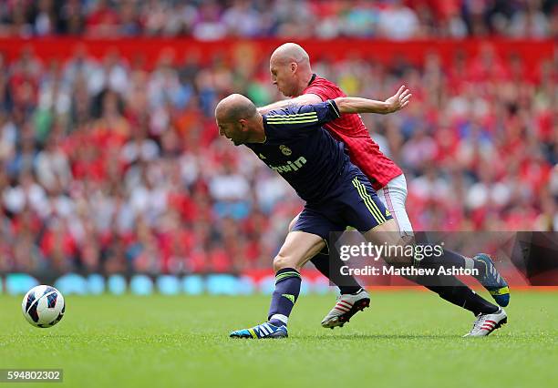 Zinedine Zidane of Real Madrid Legends and Jaap Stam of Manchester United Legends