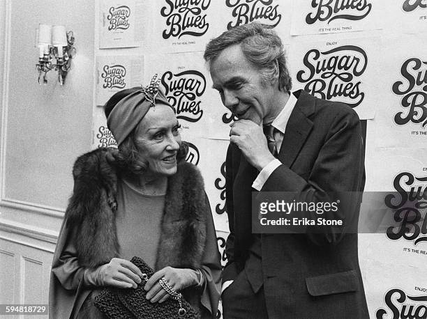 American actress Gloria Swanson with her husband William Dufty , whilst helping to publicise his book 'Sugar Blues', 1975.