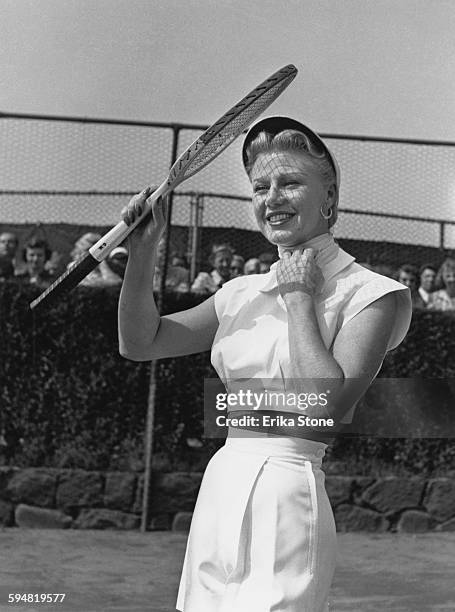 American actress and dancer Ginger Rogers playing tennis in Forest Hills, USA, circa 1950.