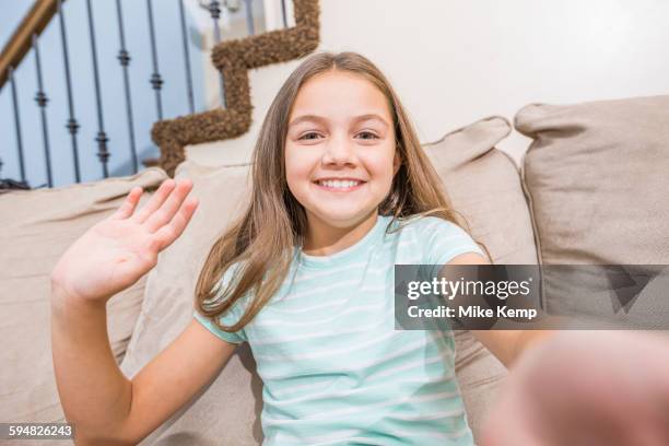 caucasian girl taking selfie on sofa - child waving stock pictures, royalty-free photos & images